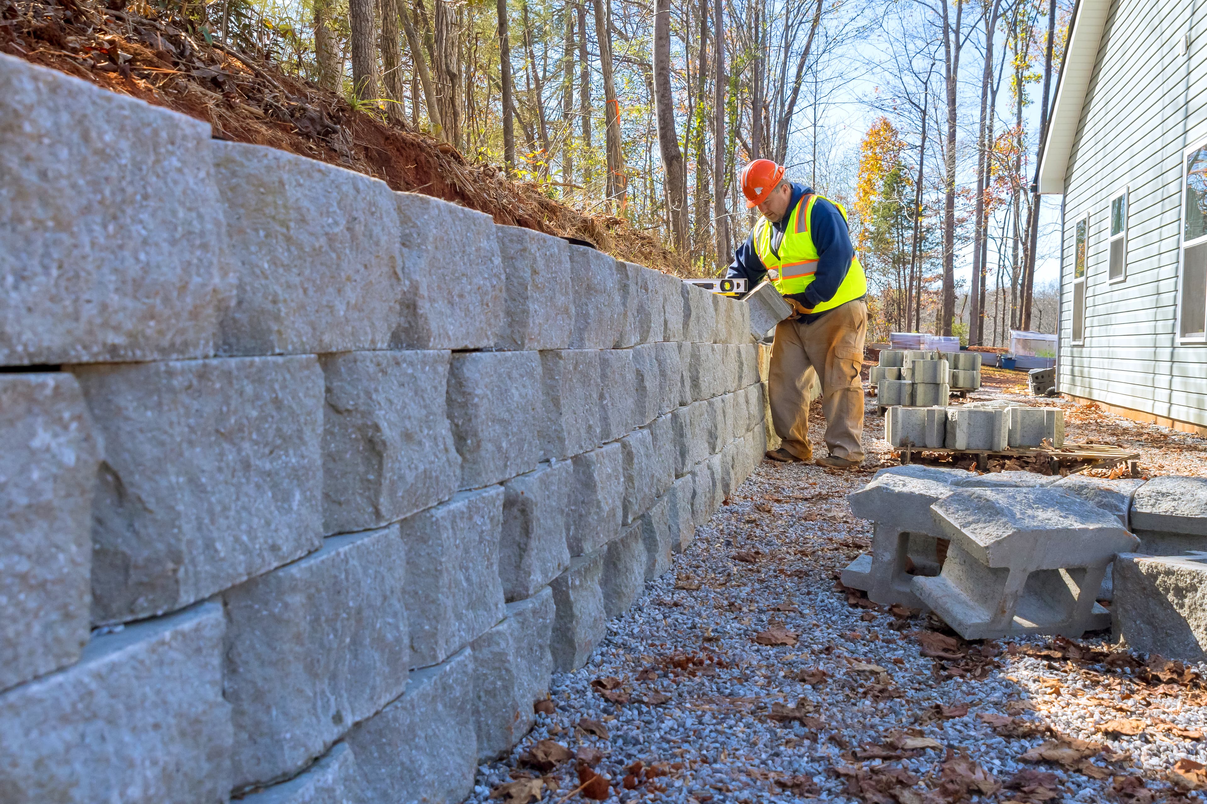 Natural stone retaining wall on sloped property